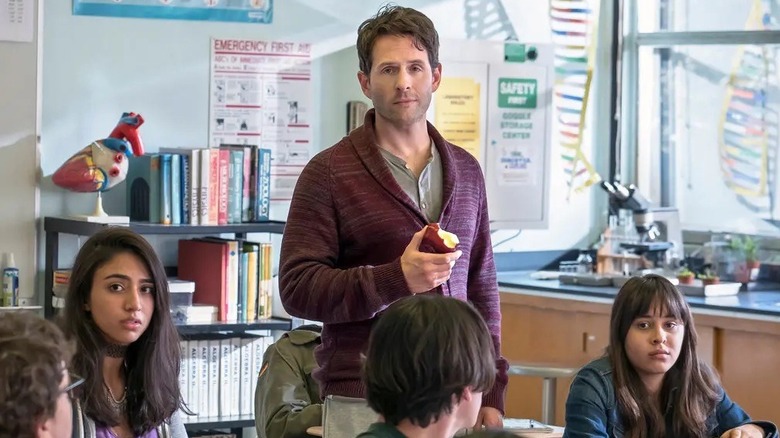 Glenn Howerton holding an apple in class in A.P. Bio