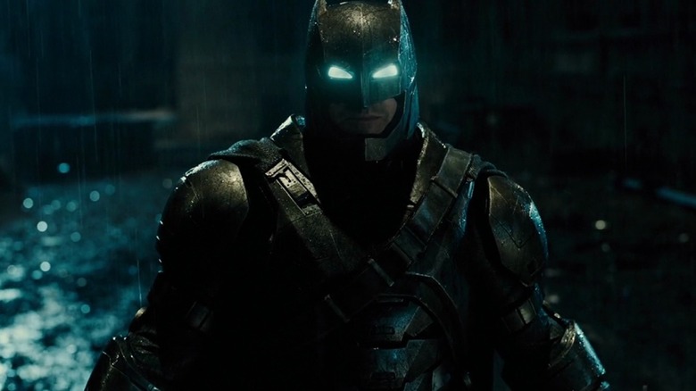 Ben Affleck as Batman in his metal suit standing in the rain in Batman v Superman: Dawn of Justice