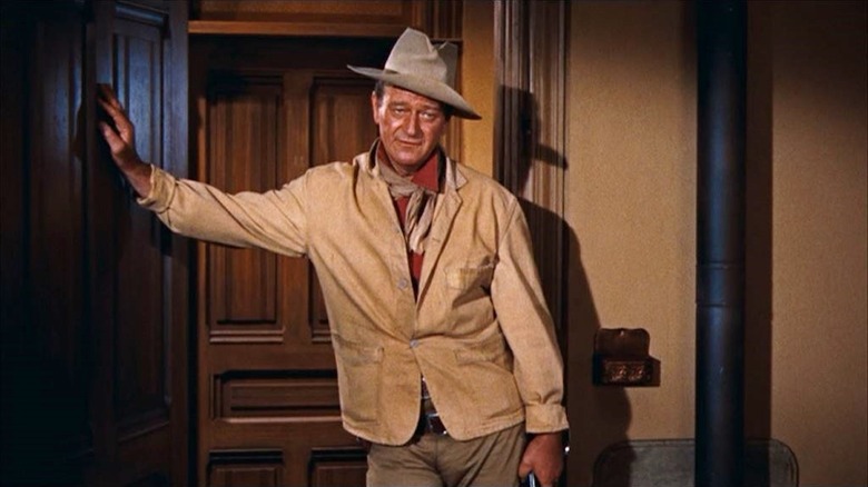 John Wayne stands in a doorway as John T. Chance in Rio Bravo