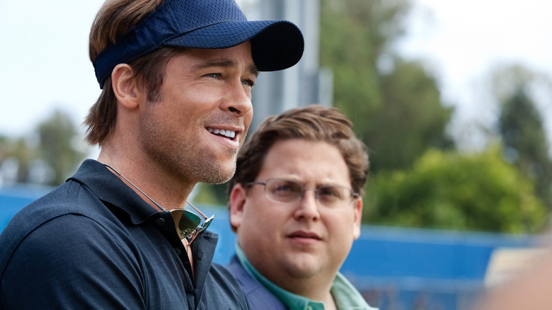 Brad Pitt as Billy Beane and Jonah Hill as Peter Brand standing together in 
