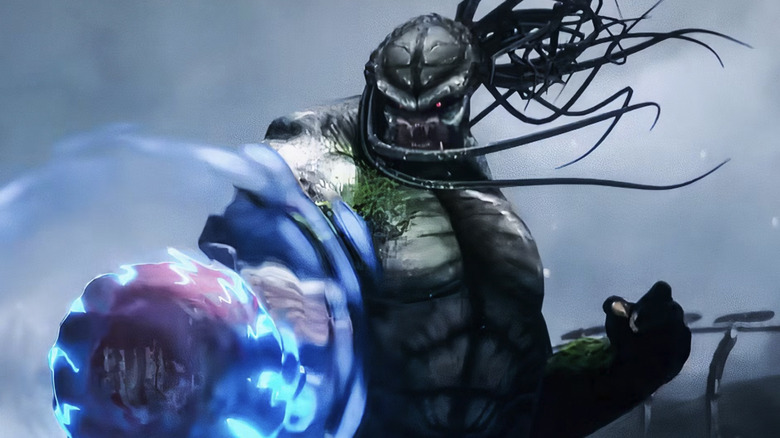 A Yautja holds a sci-fi shield in front of itself in Predator: Killer of Killers